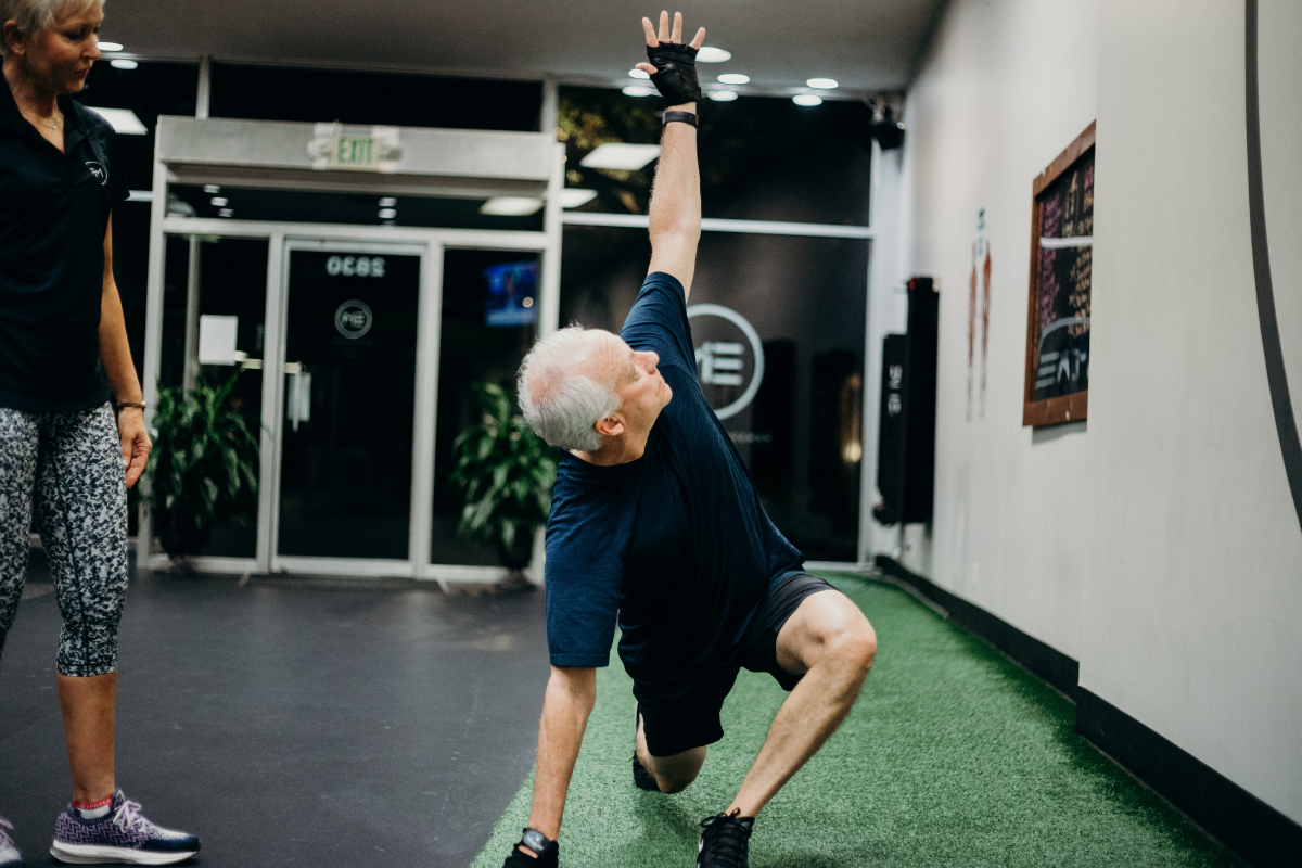 EIM personal trainer working with older male